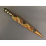 An antique Indonesian kujang with carved and painted wood handle and sheath, the handle carved