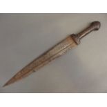 An antique Persian dagger, the hardwood handle decorated with brass studs, the blade etched with