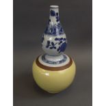 A Chinese blue and white double gourd porcelain vase with ochre glazed base and painted floral