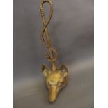 A brass door stop in the form of a fox's head and riding whip, 15" high