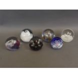 A collection of six Caithness Art glass paperweights including the designs 'Titania', 'Tidal