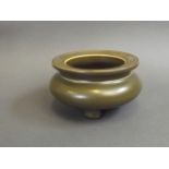 A Chinese tea dust glazed porcelain censer on tripod feet, seal mark to base, 3½" diameter
