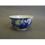 A Chinese blue and white porcelain rice bowl decorated with figures in a garden, 6 character mark to