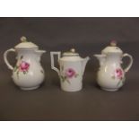 Three Meissen rose pattern coffee pots, all bearing cancelled factory marks, 6" high (AF)