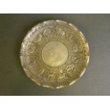 A Chinese white metal coin dish with raised zodiac animal decoration, seal mark to base, 4" diameter