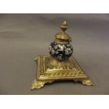 A C19th cast brass inkwell of classical form with blue and white Hawthorn pattern porcelain font and