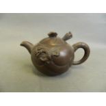 A Chinese Yixing teapot with raised dragon and carp decoration, 3½" diameter