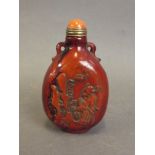 A Chinese deer horn snuff bottle with carved decoration of figures, 3" high