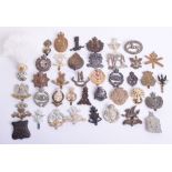 Selection of British Regimental Cap Badges, consisting of brass Machine Gun Corps cap badge with