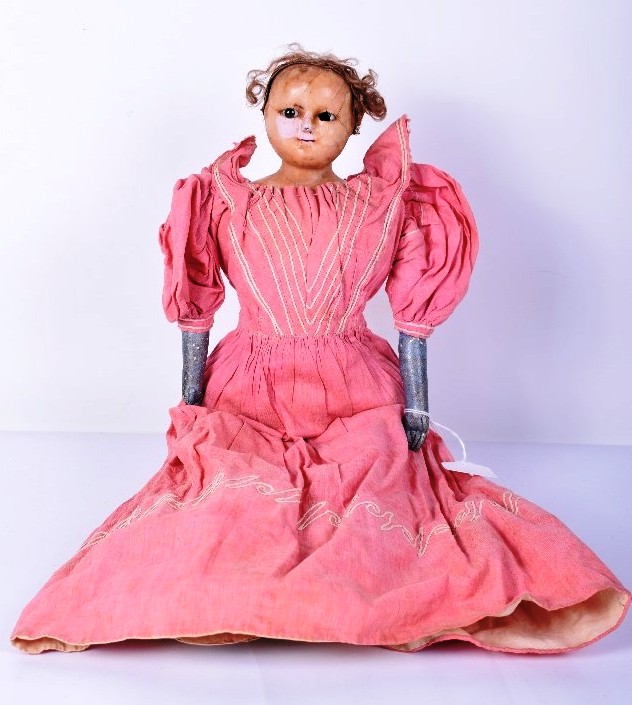 Wax over composition shoulder head doll, English circa 1840, with black pupil-less glass eye,