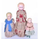 Three Pumpkin head wax over composition dolls, German circa 1860, all with black glass eyes, largest