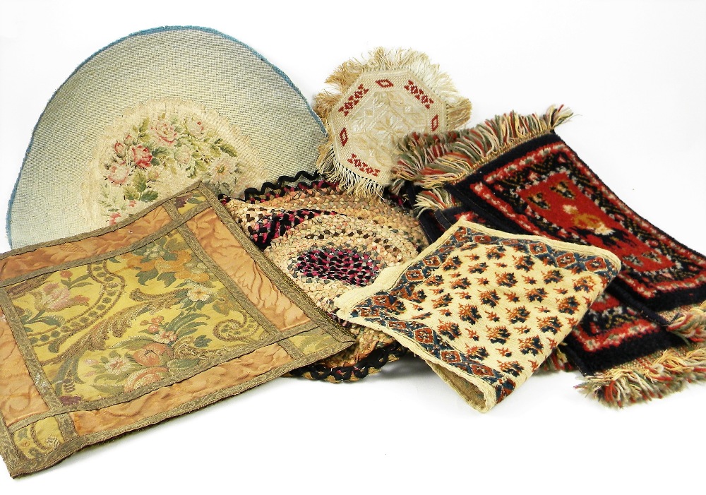 Dolls house rugs and material scraps, including four red and blue wool rugs, another in silk with