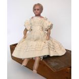 Poured wax shoulder head doll in wooden box, English 1860, with fixed blue glass eyes, painted mouth