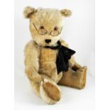 A large Chiltern Hugmee Teddy bear, English 1950’s, the blonde mohair bear with orange glass eyes,