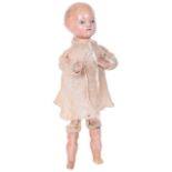 A rare wax over composition mechanical kicking Steiner Doll, French circa 1855-60, with fixed blue