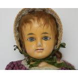 Wax over composition shoulder head doll, German circa 1860, with large blue glass eyes, painted