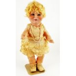 A Burggrub Princess Elizabeth bisque head doll, German late 1920s, with weighted blue glass eyes,