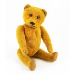 A Schuco Yes/No Teddy bear, German circa 1920, the straw filled golden short plush bear with black