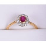 18ct Gold Ruby and Diamond Cluster Ring, 10 small diamonds set around oval shaped ruby, on 18ct gold