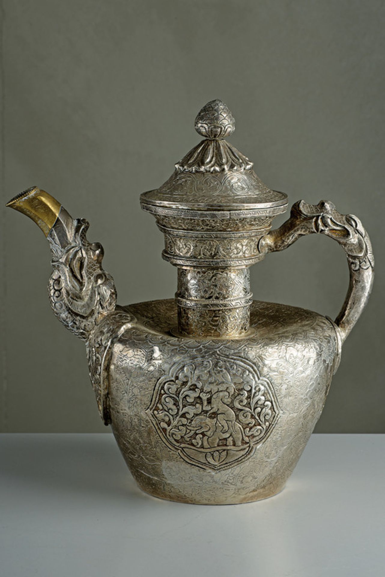 A chiselled silver teapot
