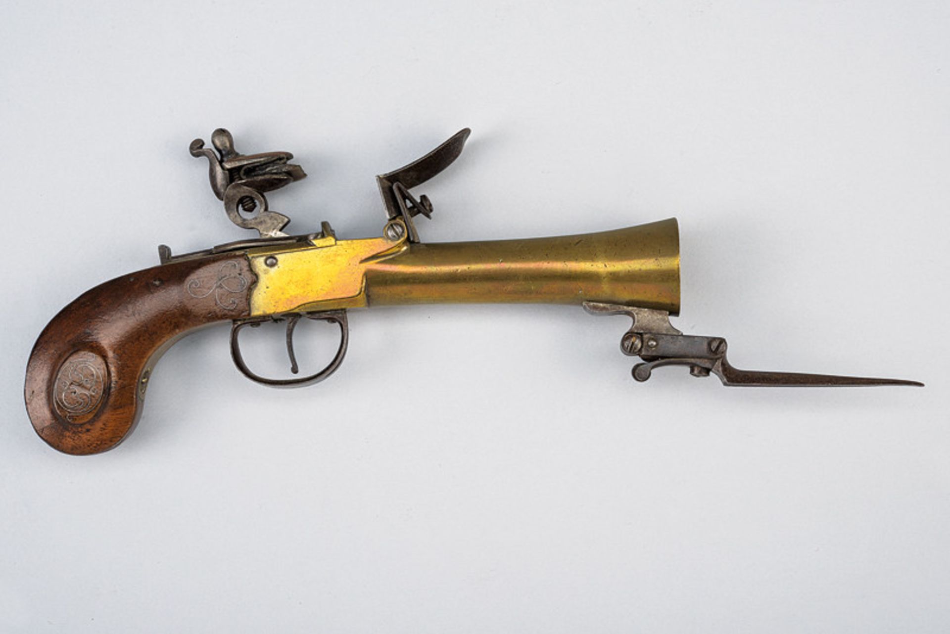 A navy flintlock pocket pistol with spring bayonet dating: first quarter of the 19th Century