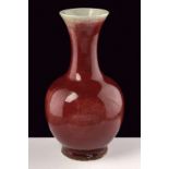 A sang de boeuf porcelain vase dating: 19th Century provenance: China Globular body, slender and