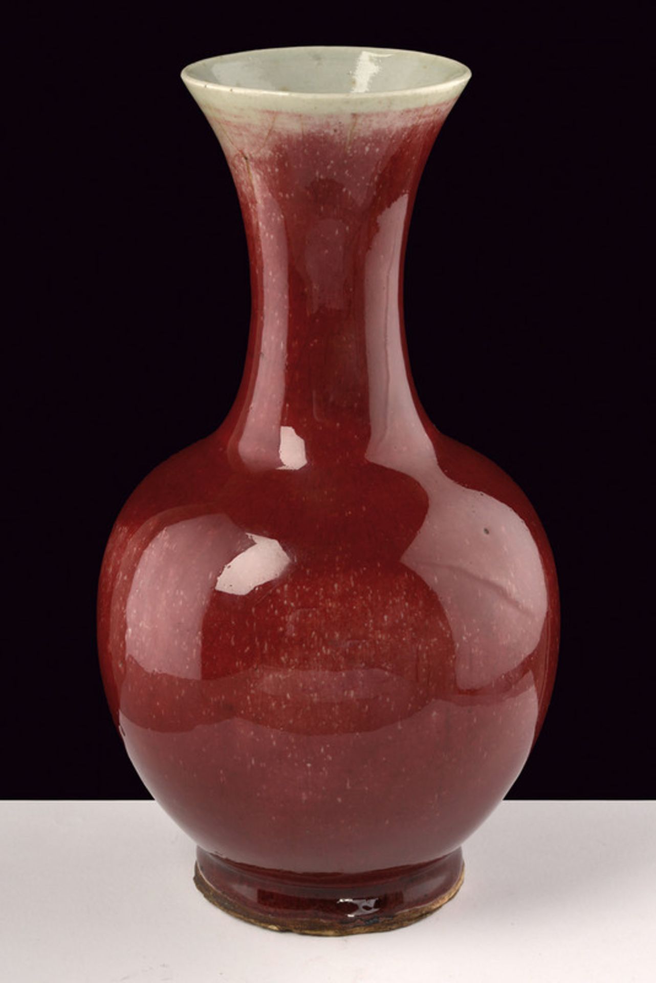 A sang de boeuf porcelain vase dating: 19th Century provenance: China Globular body, slender and