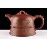 A fine Yixing tea pot dating: 19th Century provenance: China Elegant, bell shape; a relieved band