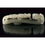 A beautiful engraved jade buckle dating: 19th Century provenance: China Finely carved with a