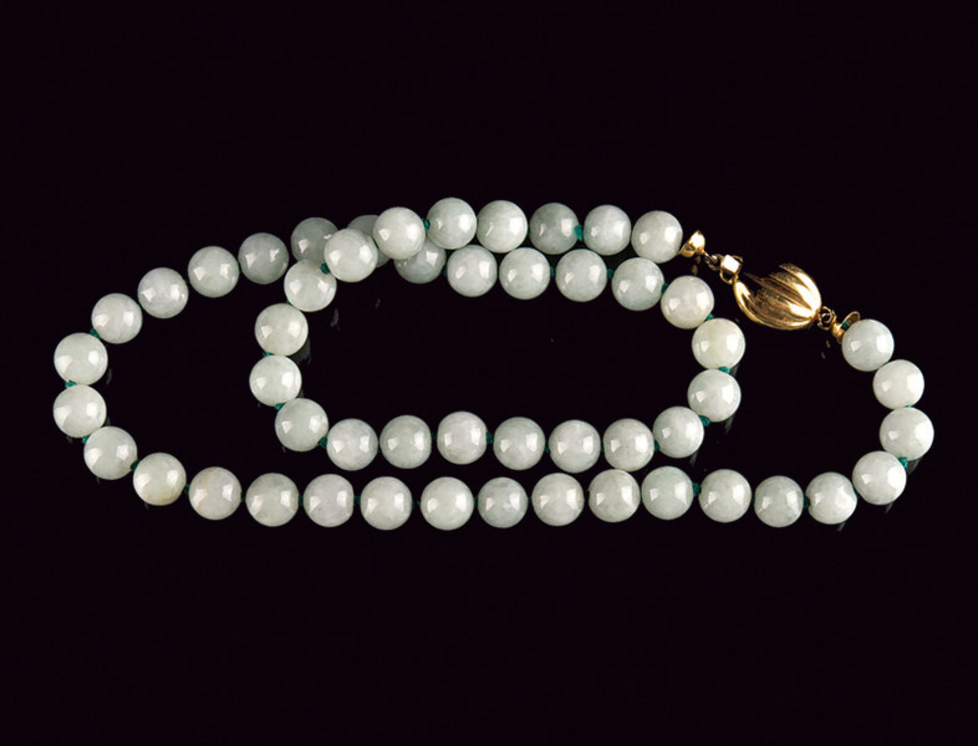 A beautiful celadon jade necklace dating: 20th Century provenance: China Consisting of one row of