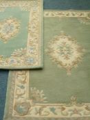 Two Indian Akbar washed woollen turquoise ground rugs