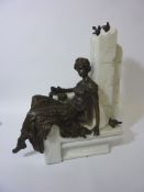 Seated bronze figure on alabaster base,