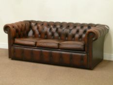 Three seat Chesterfield sofa in brown deeply buttoned leather,
