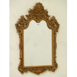 Heavily carved oak framed mirror, shaped top, decorated with foliage, W60cm,