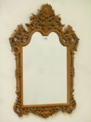 Heavily carved oak framed mirror, shaped top, decorated with foliage, W60cm,