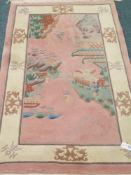 Chinese washed woollen pink ground rug,