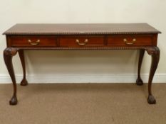 Reproduction mahogany serving table fitted with three drawers,