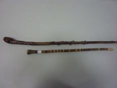 Sectional horn swagger stick and a walking stick with carved mask handle (2)