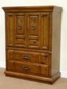 Reproduction oak finish tallboy, cupboard enclosed by two doors above two drawers,carved detail,
