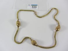 Continental gold snake chain necklace interspersed with three egg shaped links with raised