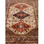 Persian Caucasian design red and beige ground rug,
