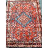 Persian Hamadan red ground rug with central medallion,