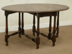 Early 20th century oak drop leaf extending dining table with fold out centre leaf, on turned gateleg