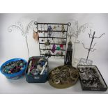 Costume jewellery in four boxes and five stands