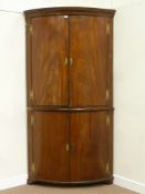 Large George III and later bow front corner cabinet, enclosed by four doors,