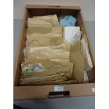 Sorted envelopes containing world stamps in one box