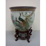 Oriental fish bowl decorated with peacocks on flowering branches,