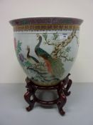 Oriental fish bowl decorated with peacocks on flowering branches,