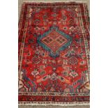 Persian Hamadan red ground rug with central medallion,