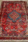 Persian Hamadan red ground rug with central medallion,